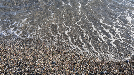 Sea water on the beach, top view