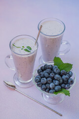 Fresh blueberry smoothie with milk in glasses