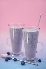 Fresh blueberry smoothie with milk in glasses