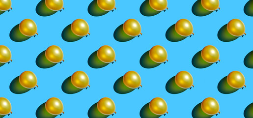 Pattern of golden balloons on blue pastel background