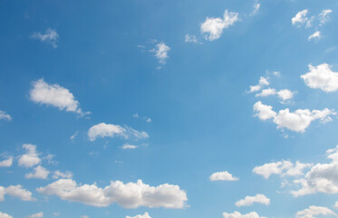 Naklejka na ściany i meble Blue sky background with white small air clouds