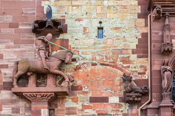 The legend Saint George is fighting against a dragon monster on the exterior wall of the Basel...