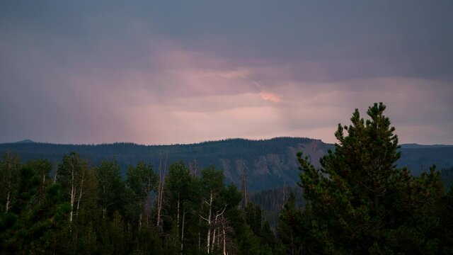 Timelapse of sunset fading on rain storm moving over the Uinta Mountains in the Utah wilderness.