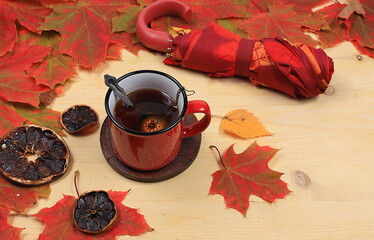 Cup of hot tea with cinnamon and seasonal leaves, autumn flower arrangement, abstract flat lay background with place for text, minimal holiday concept, thanksgiving day. rustic style,