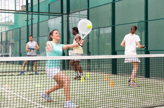 Sporty Woman And Other Athletes Training On The Tennis Court