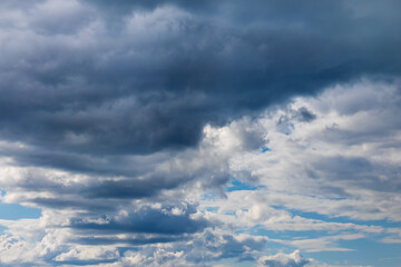 Fototapeta na wymiar Light and dark clouds on blue sky. Colorful cloudscape background.