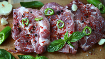 Fresh raw meat steaks on a wooden board. Grilling meat.