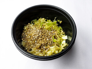 mashed fresh  coriander root with garlic and black peppers in black bowl, Thai herbs ingredients for cooking delicious food