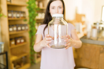 Customer showing her glass jar at the zero-waste shop