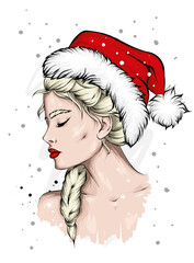 A beautiful girl in stylish clothes and a New Year's hat. New Year and Christmas, Santa Claus. Fashion & Style.