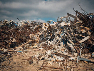 Construction site waste dump. Twisted reinforcement rebars and other construction debris. 