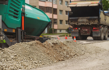 Obraz premium Road paving machine stacking asphalt on the street.