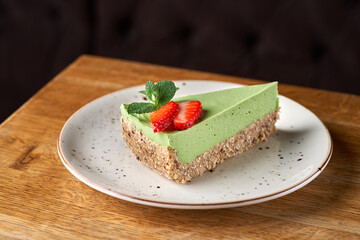 avocado lime cheesecake on a white wood background. toning. selective focus