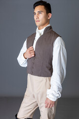 A Regency gentleman standing against a studio backdrop