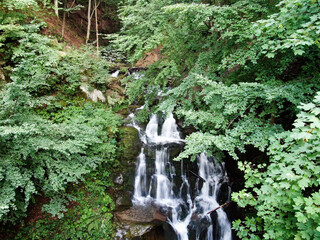 Waterfall Shypit, cascade in Pylypets in the forest. Carpathian Mountains, Zakarpatska oblast, Ukraine.