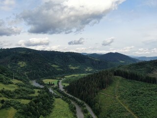 Fototapeta na wymiar Winding road from high mountain pass, in summer time. Aerial view by drone.