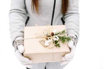 Hands of woman holding christmas gift box.