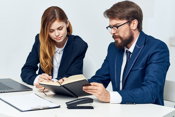 business man and woman sitting at the table in front of laptop team technology