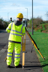 Surveyor site engineer installing tacheometer above control point before performing setting out for...