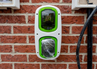 Electric vehicle domestic charging point installed outside of the house on new housing development...