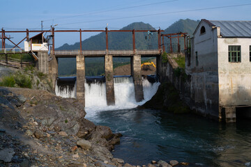 Chemal HPP. Waterfall because of the hydroelectric power station. Chepal River flows