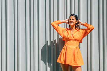 young woman in orange dress outdoors