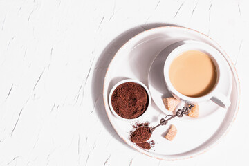 Morning cup of coffee. Ground powder, brown sugar, stand