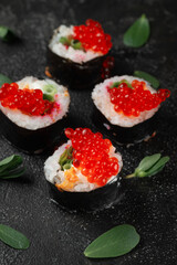 Sushi roll with reflection on a black background. Japanese kitchen and restaurant. 