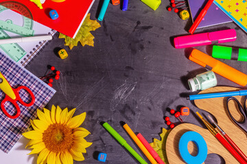 School supplies on a black chalkboard background