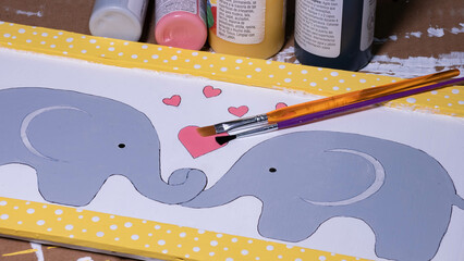 Painted elephant craft with paint brushes
