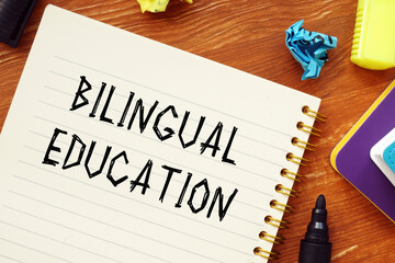 Business concept meaning BILINGUAL EDUCATION question marks with phrase on the piece of paper.