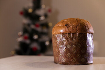 Panettone with blurry Christmas lights blinking in the background. Panettone concept. Christmas concept.
