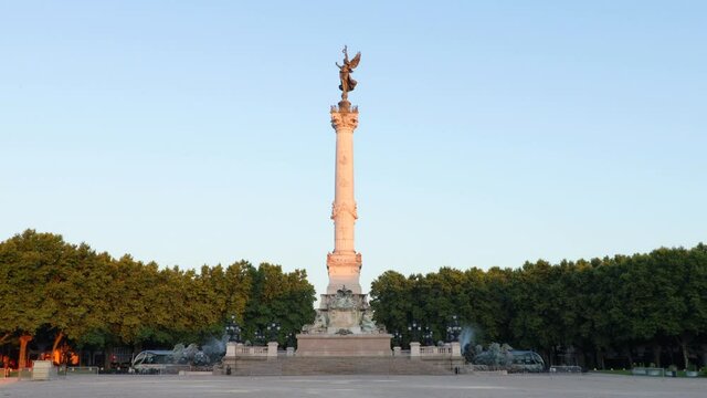 Monument aux Girondains in Bordeaux at Quinconces square during sunrise with nobody and some trams