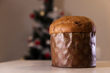 Panettone with blurry Christmas lights blinking in the background. Panettone concept. Christmas concept.
