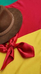 Hat, red gaucho scarf and State Flag of Rio Grande do Sul - Brazil, on the table. Decoration to...
