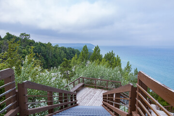 Wooden staircase down the side of a hill with Lake Michigan in background