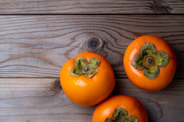 木の板の上においた柿の写真