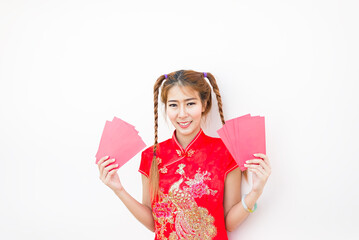 Happy asian woman in traditional chinese dress holding a red pocket with Chinese one hundred Yuan...