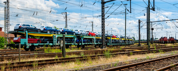 Transportation of cars by train. Autorack with cars. Loaded cars ready for transport