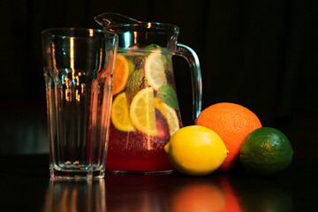 summer refreshing, lemonade drink. mix of fruits. lemon, lime, orange, mint. decanter and glass...