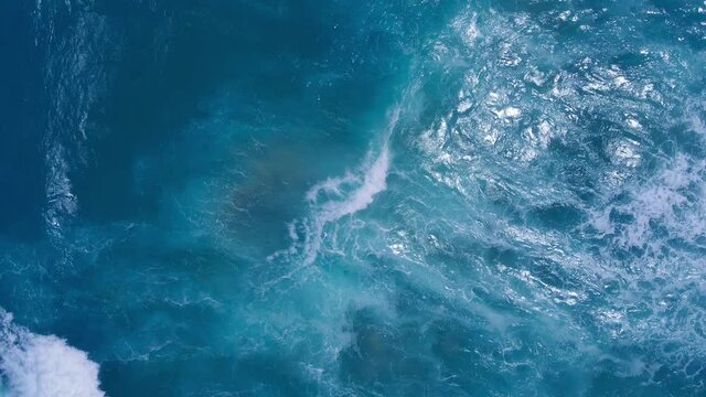 (Top view) drone view shot. on the Andaman coast. Beautiful big wave seawater wave texture. The sea and large ripples that wash against the shore are filled with beautiful soft white sponges.