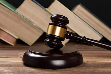 gavel on a table with some books on background