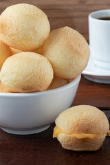 Traditional snack cheese bread (pão de queijo) served with cheese and coffee.