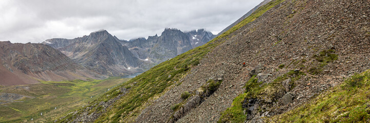 Fototapeta na wymiar Mountain peaks of Tombstone Territorial Park in northern Canada, during summer time with cloudy, foggy, misty weather and amazing, huge landscape, taken from Grizzly Lake hiking trail. 
