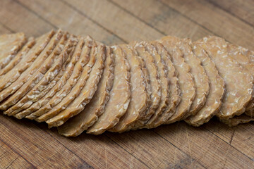 sliced tempeh on wooden board closeup selective focus