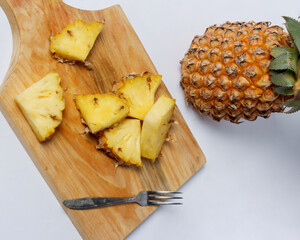 Whole pineapple isolated on a bright background. Close-up view of fresh and delicious pineapple. Overripe pineapples that begin to rot will release a sweet, honey-like liquid. Focus blur. Pineapple mo