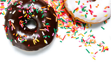 Chocolate, vanilla, and maple frosted donuts with rainbow sprinkles on a white background