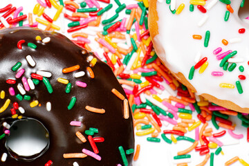 Close up of a chocolate and vanilla frosted donut with rainbow sprinkles 
