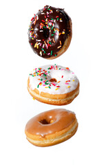 Chocolate, vanilla, and maple frosted donuts with rainbow sprinkles falling on a white background