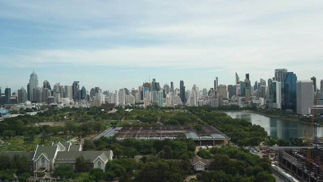 Queen Sirikit National Convention Centre construction site near Benjakitti Park and Lake, Millenium Residence Apartment, CTI Tower, Ocean Tower in Bangkok,  on Sunny day from Top, cityscape time-lapse